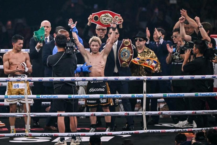 Naoya Inoue (C) celebrates defeating Junto Nakatani in their super bantamweight championship boxing contest at Tokyo Dome in Tokyo on May 2, 2026.  Yuichi YAMAZAKI / AFP