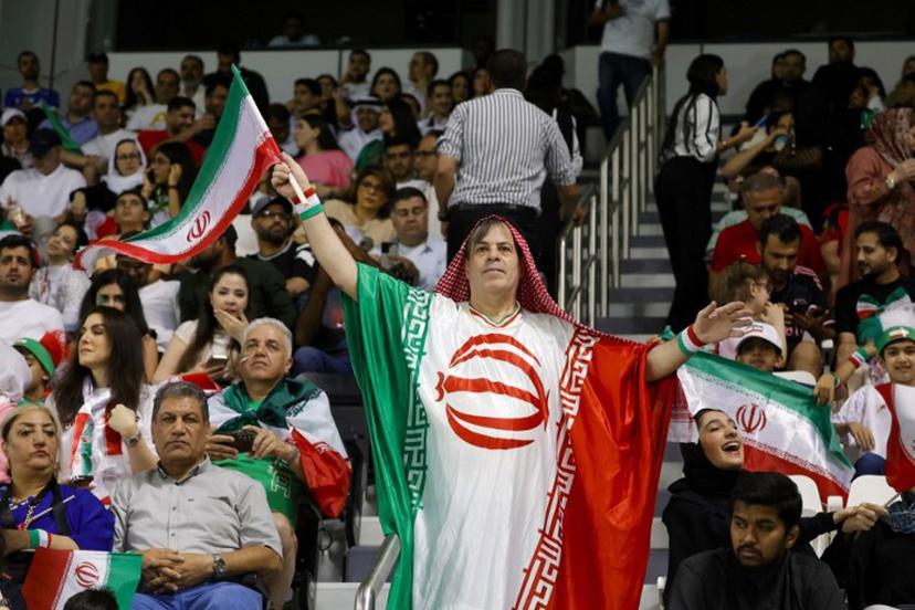 An Iran fan cheers ahead of the 2026 FIFA World Cup Asian Qualifier football match between Qatar and Iran at Jassim Bin Hamad Stadium in Doha on June 5, 2025.  Karim JAAFAR / AFP