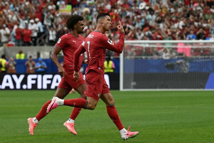 Portugal's forward #07 Cristiano Ronaldo (R) celebrates after scoring the opening goal during the 2026 World Cup Group K football match between Portugal and Uzbekistan at the Houston Stadium in Houston on June 23, 2026.   RONALDO SCHEMIDT / AFP