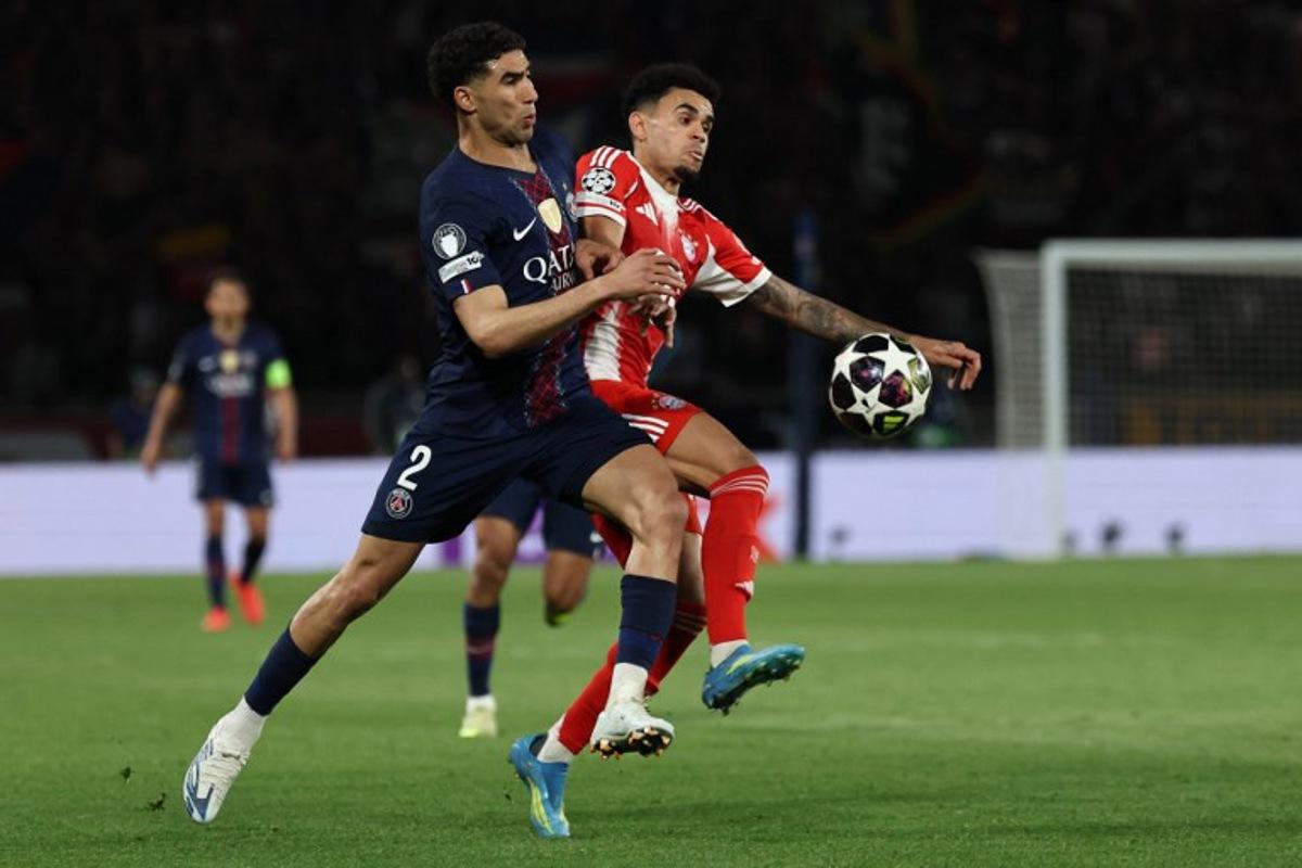 Paris Saint-Germain's Moroccan defender #02 Achraf Hakimi fights for the ball with Bayern Munich's Colombian forward #14 Luis Diaz during the UEFA Champions League semi-final first leg football match between Paris Saint-Germain (PSG) and Bayern Munich at the Parc des Princes in Paris on April 28, 2026.  Anne-Christine POUJOULAT / AFP