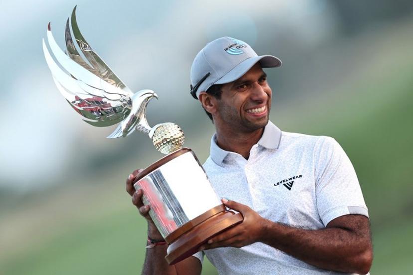 England's Aaron Rai poses with his trophy after winning the European Tour of Abu Dhabi Championship 2025 golf tournament in Abu Dhabi on November 9, 2025. Aaron Rai showed nerves of steel to beat Tommy Fleetwood on the first extra hole and win the Abu Dhabi Championship on November 9. The win was the 30-year-old Rai's third on the DP World Tour but his first since 2020. His last title came on the US Tour at the Wyndham Championship nearly 14 months ago. Fadel SENNA / AFP