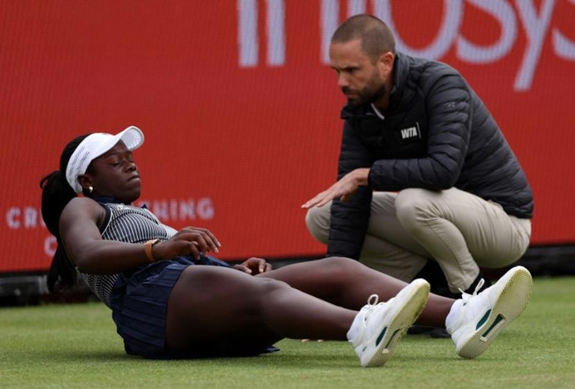 Canada's Victoria Mboko reacts after slipping on the grass attempting to play a return shot against Czech Republic's Karolina Pliskova during their round of 16 women's singles match at the HSBC WTA tennis Championships at Queen's Club in west London on June 10, 2026. Pliskova won the match 6-2, 3-4 after Mboko retired in the second set. Adrian Dennis / AFP