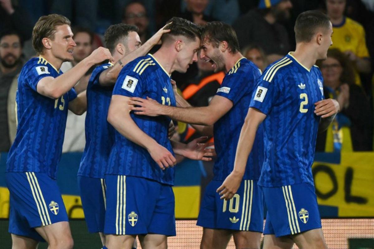 Sweden's forward #17 Viktor Gyokeres (3L) celebrates scoring his team's second goal with Sweden's forward #10 Benjamin Nygren (2R) during the 2026 World Cup qualifiers Europe zone semifinal football match between Ukraine and Sweden at Ciutat de Valencia Stadium in Valencia on March 26, 2026.  JOSE JORDAN / AFP