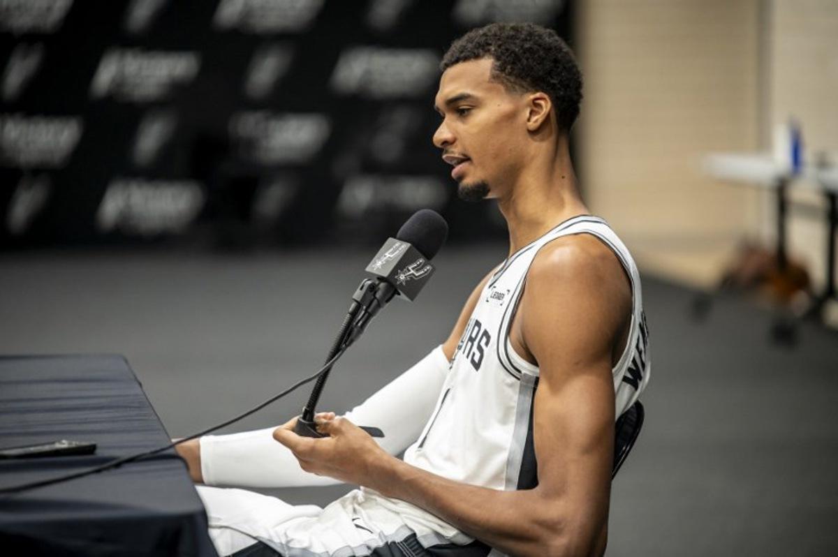 French basketball player Victor Wembanyama speaks to journalists during the San Antonio Spurs media day at the Victory Capital Performance Center in San Antonio, Texas on September 29, 2025. Wembanyama has been cleared by the team's medical staff to play for the upcoming season. SERGIO FLORES / AFP