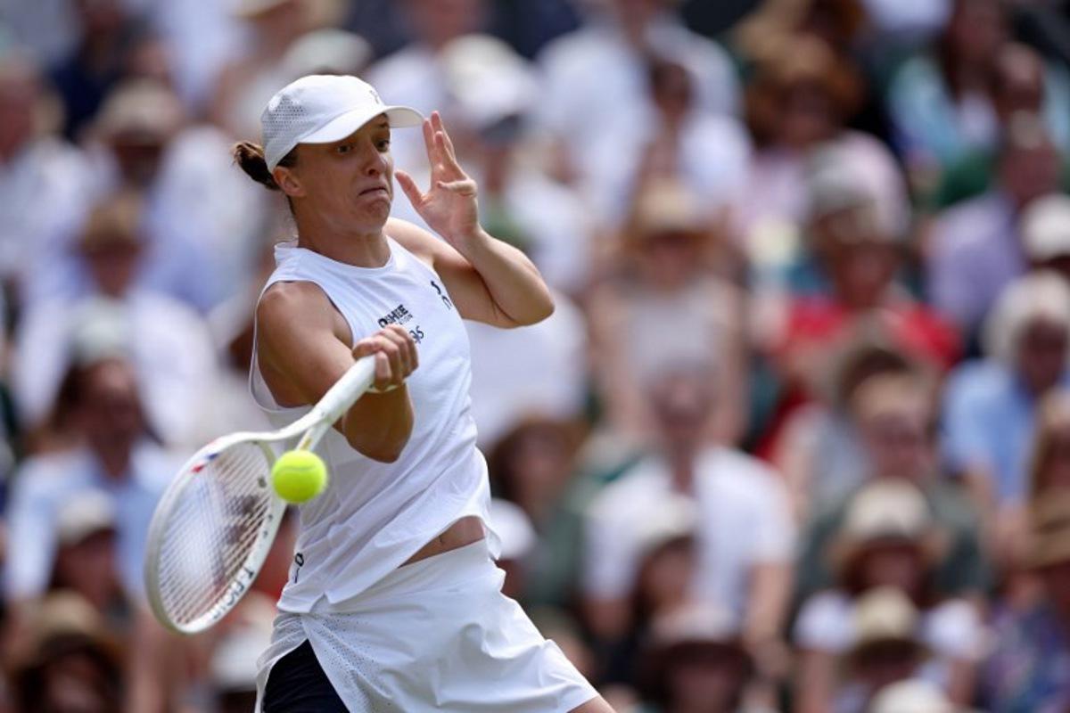 Poland's Iga Swiatek returns to Philippines' Alexandra Eala during their women's singles third round tennis match on the sixth day of the 2026 Wimbledon Championships at The All England Lawn Tennis and Croquet Club in Wimbledon, southwest London, on July 4, 2026.  Henry Nicholls / AFP