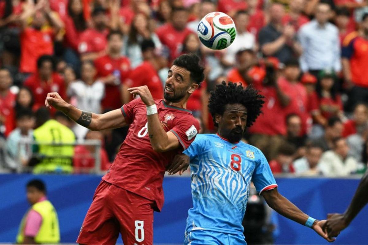 Portugal's midfielder #08 Bruno Fernandes (L) fights for the ball with Congo DR's midfielder #08 Samuel Moutoussamy  during the 2026 World Cup Group K football match between Portugal and the Democratic Republic of Congo at the Houston Stadium in Houston on June 17, 2026.   RONALDO SCHEMIDT / AFP