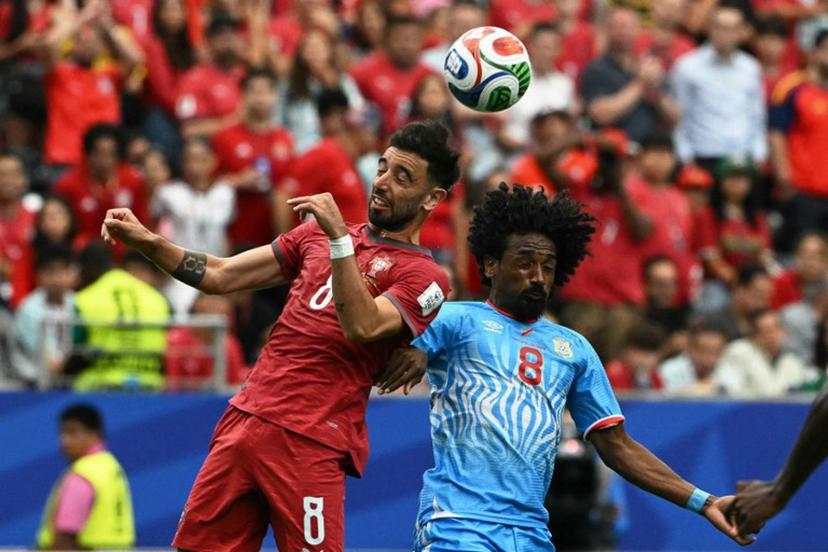 Portugal's midfielder #08 Bruno Fernandes (L) fights for the ball with Congo DR's midfielder #08 Samuel Moutoussamy  during the 2026 World Cup Group K football match between Portugal and the Democratic Republic of Congo at the Houston Stadium in Houston on June 17, 2026.   RONALDO SCHEMIDT / AFP