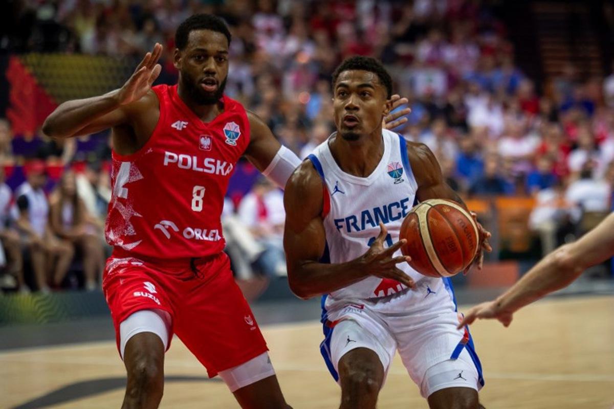 Poland's shooting guard #08 Jordan Loyd and France's point guard #11 Theo Maledon vie during the FIBA EuroBasket 2025 Group D basketball match between France and Poland at the Spodek Arena in Katowice, Poland on September 2, 2025.  Wojtek RADWANSKI / AFP
