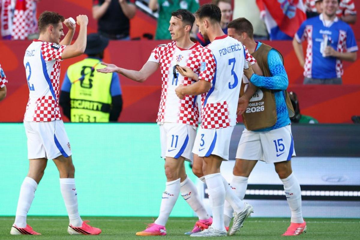 Croatia's forward #11 Ante Budimir celebrates with teammates scoring his team's first goal during the 2026 World Cup Group L football match between Panama and Croatia at the Toronto Stadium in Toronto on June 23, 2026.   Cole Burston / AFP