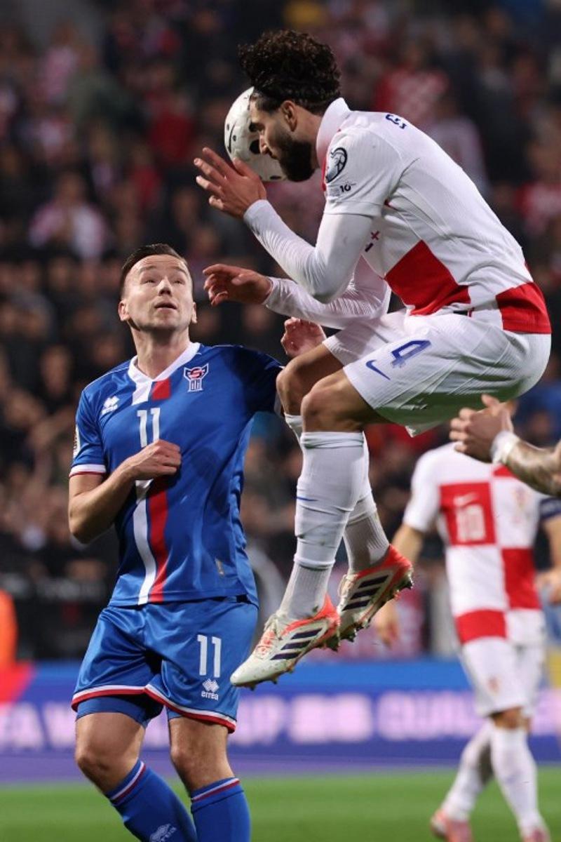 Croatia's defender #04 Josko Gvardiol (R) fights for the ball with Faroe's midfielder #11 Arni Frederiksberg during the 2026 World Cup qualifiers Europe zone group L football match between Croatia and Faroe Islands at the Stadion HNK in Rijeka, on November 14, 2025.   STRINGER / AFP