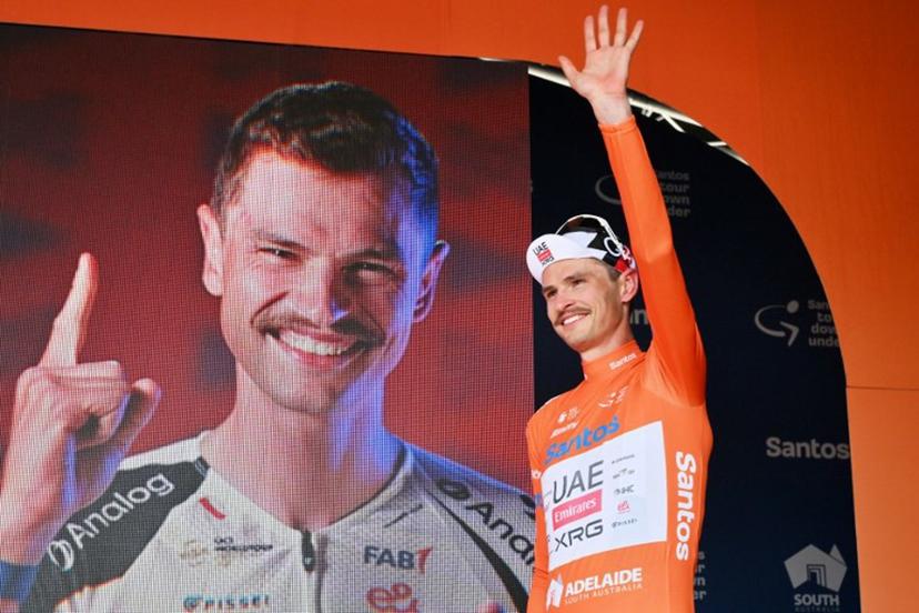 Race leader UAE Team Emirates XRG's Australian rider Jay Vine waves onstage as he continues to wear the leader's jersey after stage four of the Tour Down Under UCI men's cycling race in Adelaide on January 24, 2026.   Brenton Edwards / AFP