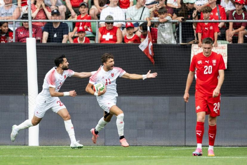 Jordan's forward #11 Odeh Fakhoury (C) celebrates scoring his team's first goal during a friendly match between Switzerland and Jordan ahead of the 2026 FIFA World Cup football tournament at the Kybunpark stadium, in St. Gallen, on May 31, 2026.  Ennio LEANZA / AFP