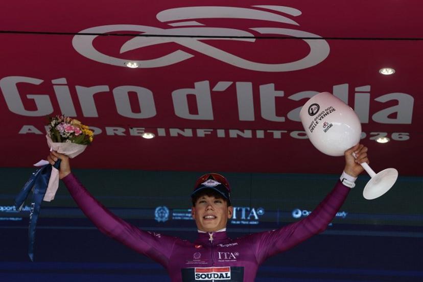 Soudal Quick-Step French rider Paul Magnier celebrates his mauve jersey (Maglia Ciclamino) of best sprinter on the podium  after the 10th stage of the Giro d'Italia 2026 - Tour of Italy cycling race, 42km individual time trial between Viareggio and Massa on May 19, 2026. ,  Luca Bettini / AFP