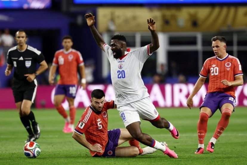 Scotland's defender #05 Grant Hanley and Haiti's forward #20 Frantzdy Pierrot fight for the ball during the 2026 World Cup Group C football match between Haiti and Scotland at the Boston Stadium in Foxborough on June 13, 2026.  FRANCK FIFE / AFP