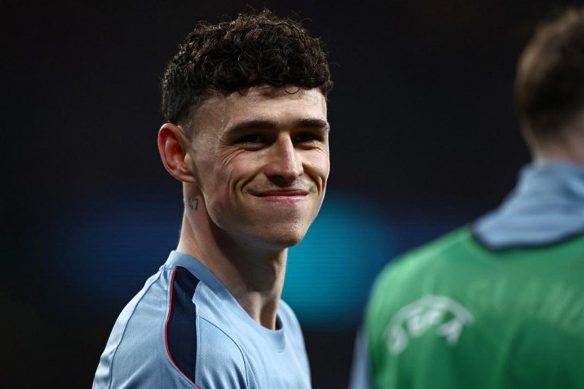 England's midfielder Phil Foden smiles as he warms up ahead of the friendly International football match between England and Uruguay at Wembley Stadium, west London, on March 27, 2026.  Henry NICHOLLS / AFP