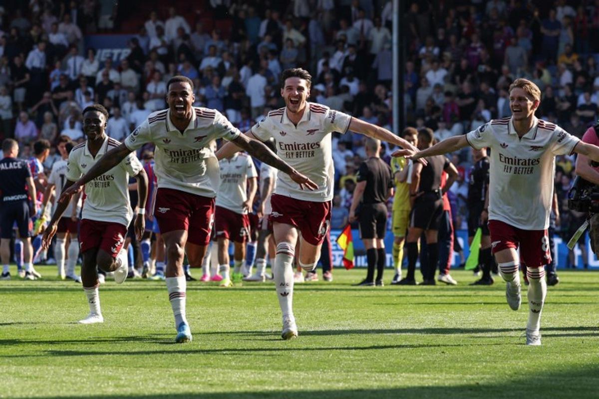 Arsenal players celebrate with supporters at the end of the English Premier League football match between Crystal Palace and Arsenal at Selhurst Park in south London on May 24, 2026.  Adrian Dennis / AFP