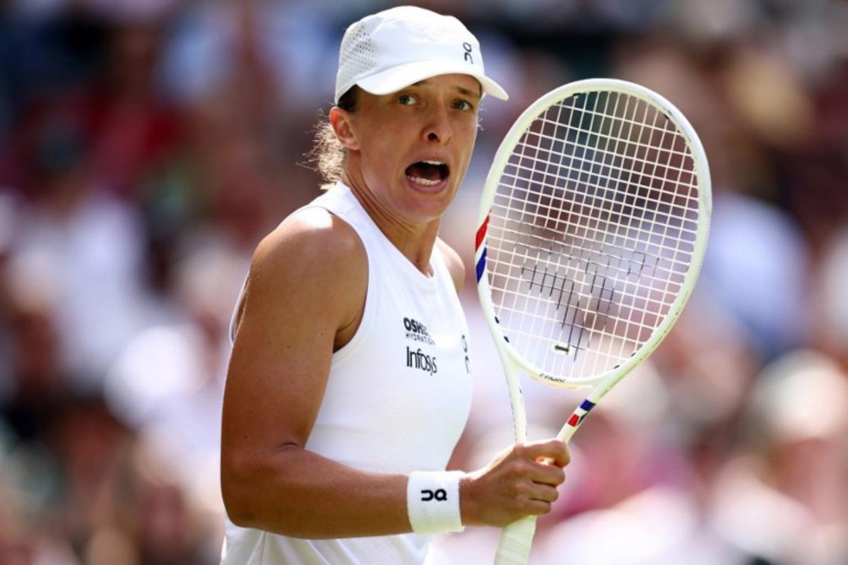 Poland's Iga Swiatek celebrates beating US player Taylor Townsend during their women's singles first round tennis match on the second day of the 2026 Wimbledon Championships at The All England Lawn Tennis and Croquet Club in Wimbledon, southwest London, on June 30, 2026.  Henry Nicholls / AFP