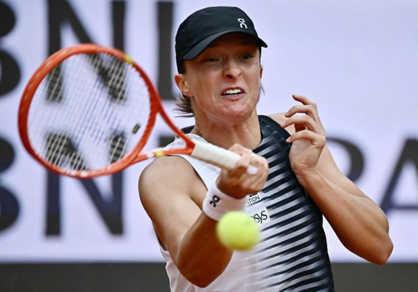 Poland's Iga Swiatek hits a return to USA's Jessica Pegula during the ATP Rome Open tennis tournament at Foro Italico in Rome on May 13, 2026.   Filippo MONTEFORTE / AFP