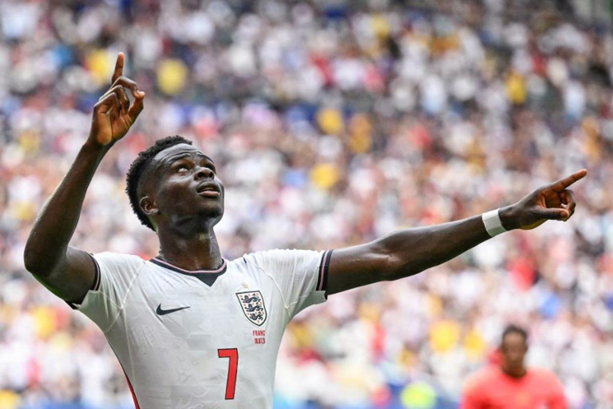 England's forward #07 Bukayo Saka celebrates scoring his team's fourth goal during the 2026 World Cup football tournament third-place match between France and England at the Miami Stadium in Miami on July 18, 2026.   CHANDAN KHANNA / AFP
