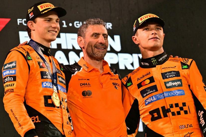 McLaren's Australian driver Oscar Piastri and McLaren's British driver Lando Norris stand on the podium with McLaren team principal Andrea Stella after the Bahrain Formula One Grand Prix at the Bahrain International Circuit in Sakhir on April 13, 2025.  Giuseppe CACACE / AFP