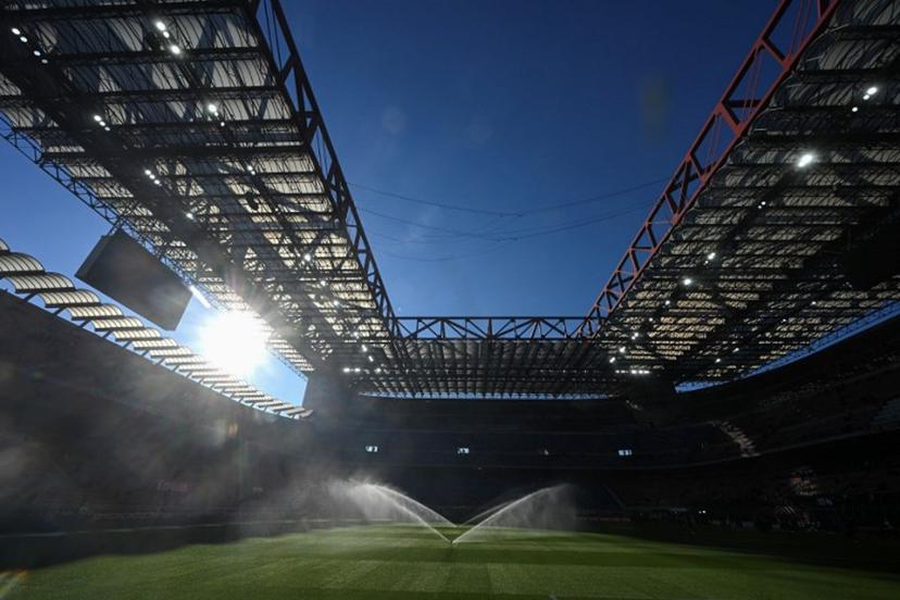 Sprinklers spray water on the pitch ahead of the Italian Serie A football match between AC Milan and Sassuolo at the San Siro Stadium in Milan, Italy on December 14, 2025.  Piero CRUCIATTI / AFP