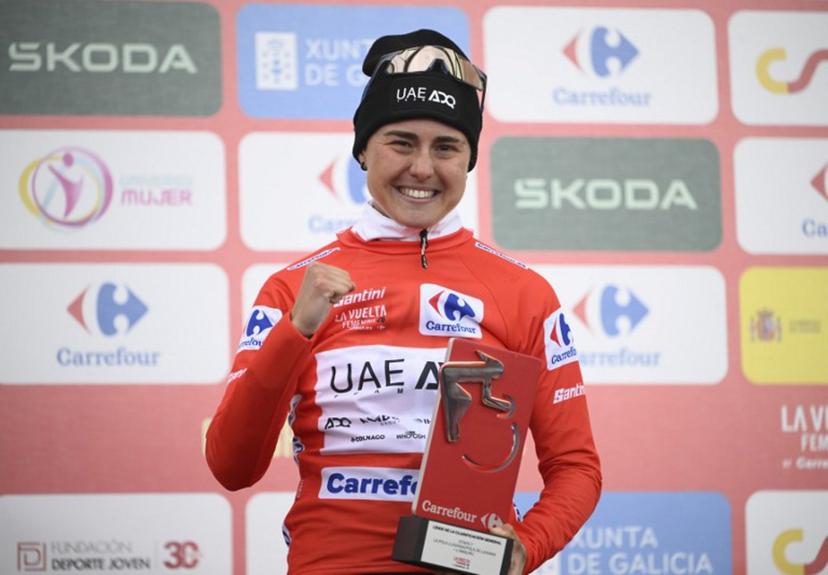 Winner of 2026 La Vuelta Femenina cycling tour of Spain, team UAE ADQ's Spanish rider Paula Blasi Cairol celebrates on the podium after the 7th stage, a 132.9 km race between Pola de Laviana and Alto de l'Angliru, on May 9, 2026.   Miguel RIOPA / AFP