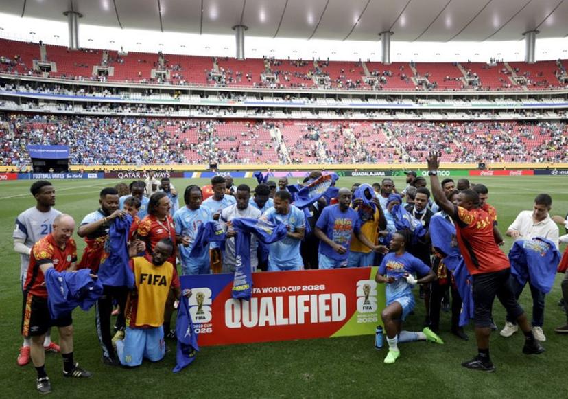 DR Congo players and coaching staff celebrate after winning the match and qualifying for the World Cup during the 2026 FIFA World Cup qualifiers final playoff football match between the Democratic Republic of the Congo and Jamaica at the Akron Stadium in Zapopan, Jalisco state, Mexico, on March 31, 2026.  Ulises Ruiz / AFP