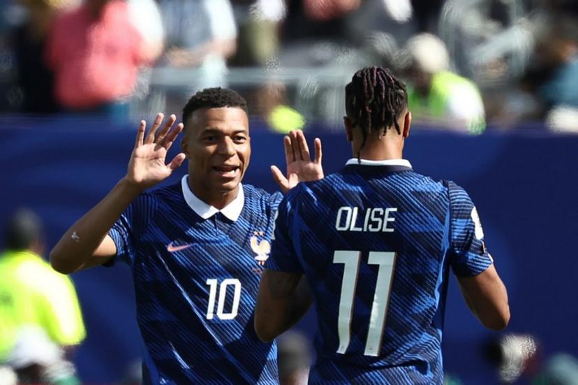 France's forward #10 Kylian Mbappe celebrates with teammate France's forward #11 Michael Olise after scoring his team's first goal during the 2026 World Cup Group I football match between France and Senegal at the New York/New Jersey Stadium in East Rutherford on June 16, 2026.   FRANCK FIFE / AFP