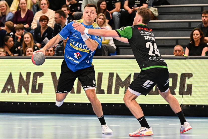 Bocholts Yannick Glorieux and Hubo Handbal's Valentin Bzdynga pictured in action during a handball game between Achilles Bocholt and HUBO Handbal, Saturday 04 April 2026, in Hasselt, the men's final of the Belgian handball cup. BELGA PHOTO JILL DELSAUX