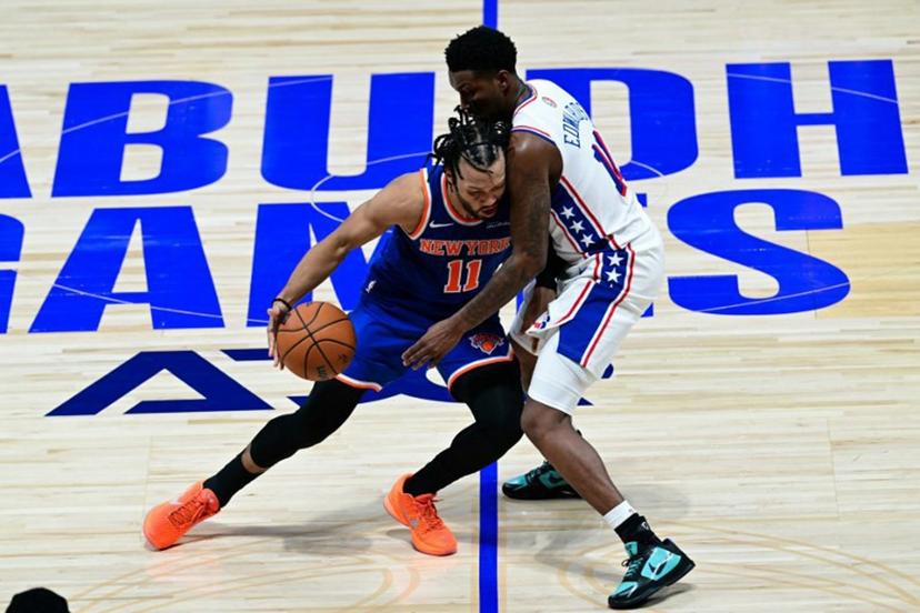 New York Knicks' #11 Jalen Brunson dribbles against Philadelphia 76ers' #11 Justin Edwards during the NBA basketball game between the New York Knicks and the Philadelphia 76ers at the Etihad Arena in Abu Dhabi on October 2, 2025.  Giuseppe CACACE / AFP