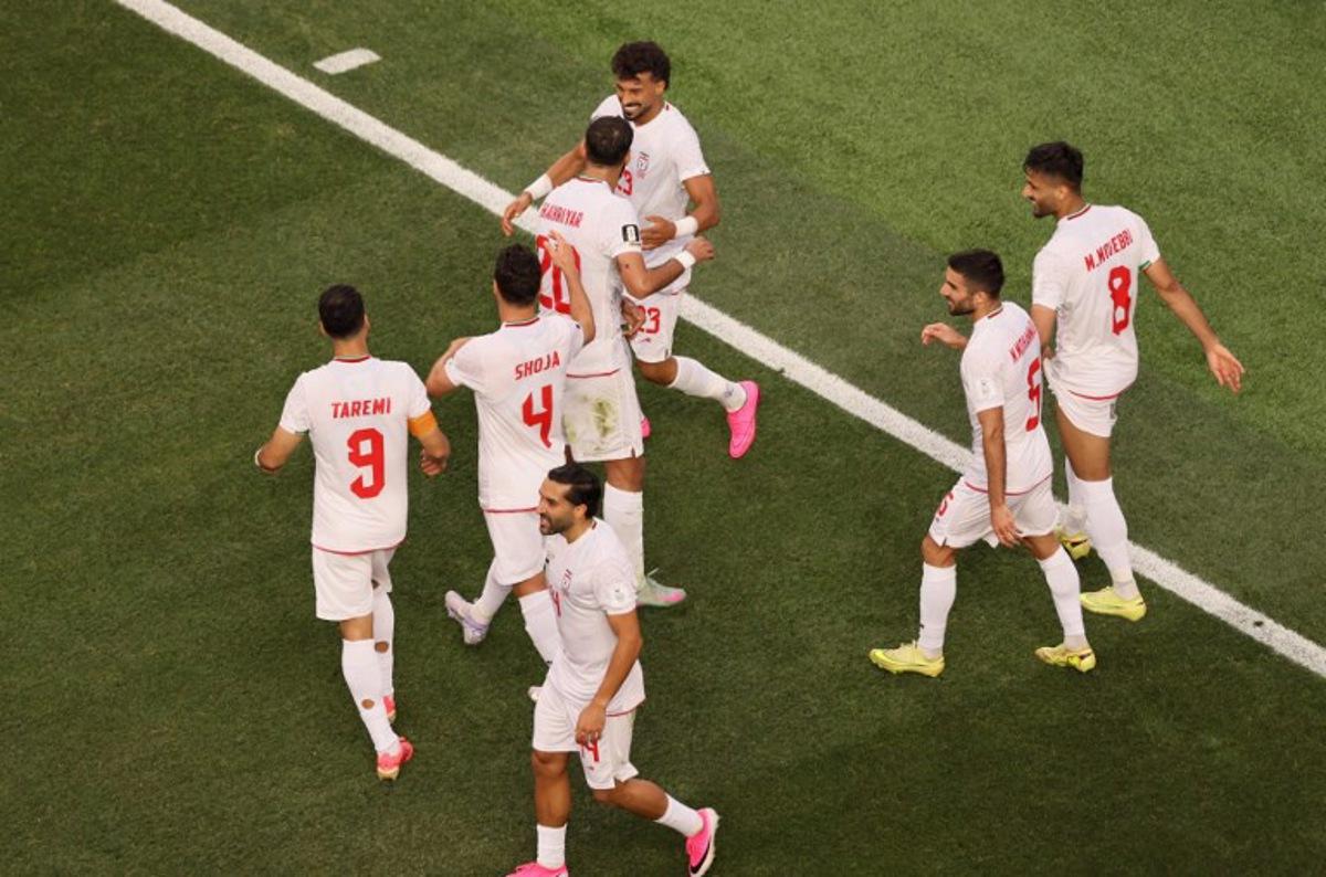 Iran's defender #23 Ramin Rezaeian celebrates with teammates after scoring his team's first goal during the 2026 World Cup Group G football match between Iran and New Zealand at Los Angeles Stadium in Inglewood on June 15, 2026.   Etienne Laurent / AFP