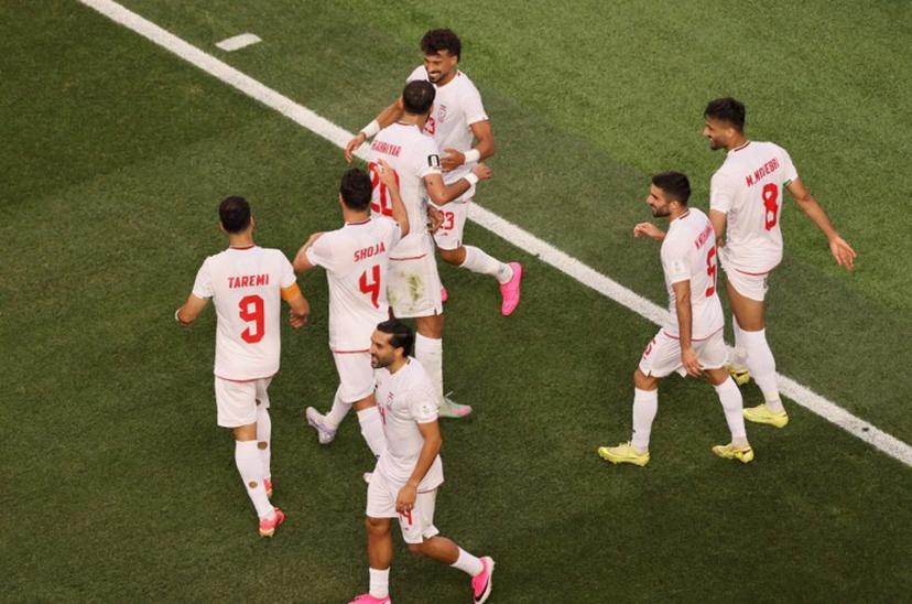 Iran's defender #23 Ramin Rezaeian celebrates with teammates after scoring his team's first goal during the 2026 World Cup Group G football match between Iran and New Zealand at Los Angeles Stadium in Inglewood on June 15, 2026.   Etienne Laurent / AFP