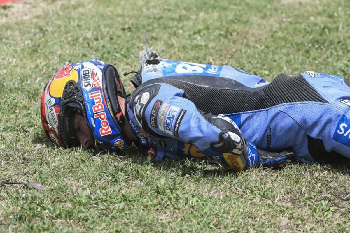 Team Gresini Racing MotoGP's Alex Marquez lies on the side of the track after crashing at high speed during the 2026 Catalunya Moto GP Grand Prix at the Catalunya racetrack in Montmelo, near Barcelona, on May 17, 2026.  JOSE JORDAN / AFP