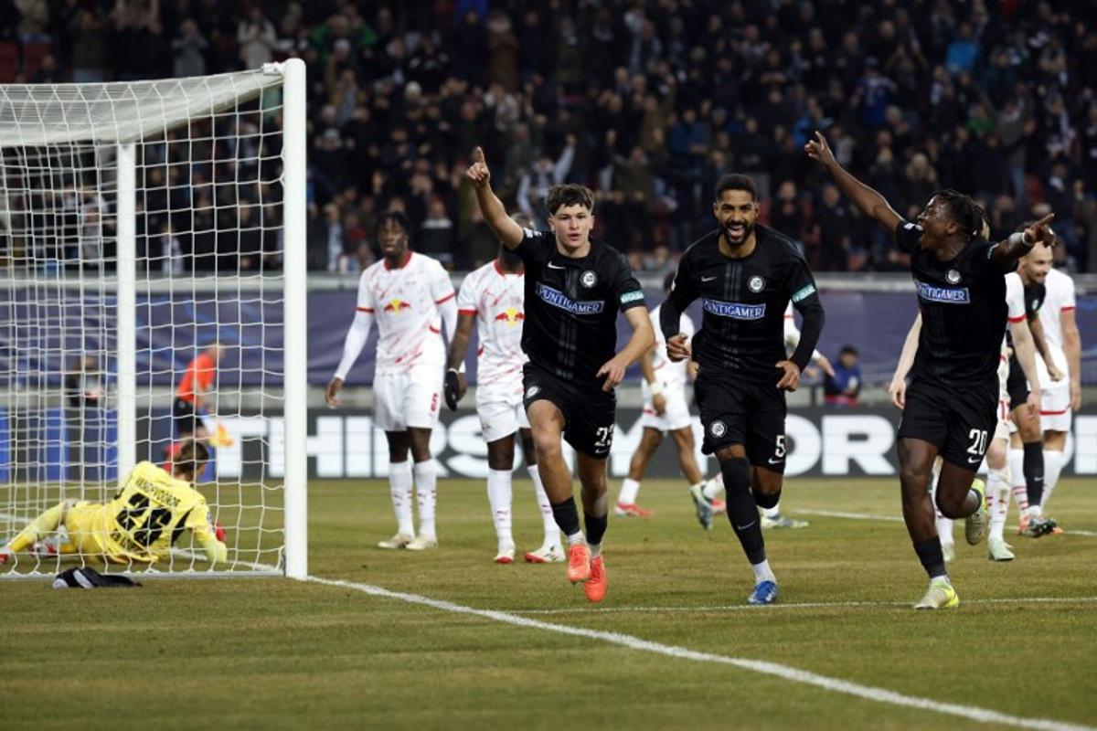 Sturm Graz's Slovenian defender #23 Arjan Malic (2L) celebrates with teammates Sturm Graz's Swiss defender #05 Gregory Wuethrich (2R) and Sturm Graz's Norwegian forward #20 Seedy Jatta after he scored his team's first goal past Leipzig's Belgian goalkeeper #26 Maarten Vandevoordt during the UEFA Champions League football match between SK Sturm Graz and RB Leipzig in Klagenfurt, Austria on January 29, 2025.  ERWIN SCHERIAU / APA / AFP