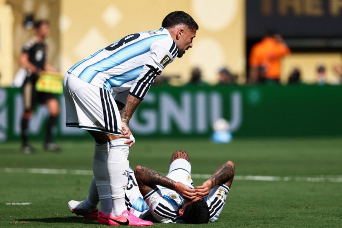 Argentina's defender #13 Cristian Romero (R) lies on the field past defender #19 Nicolas Otamendi during the 2026 World Cup football tournament final match between Spain and Argentina at the New York/New Jersey Stadium in East Rutherford on July 19, 2026.   FRANCK FIFE / AFP