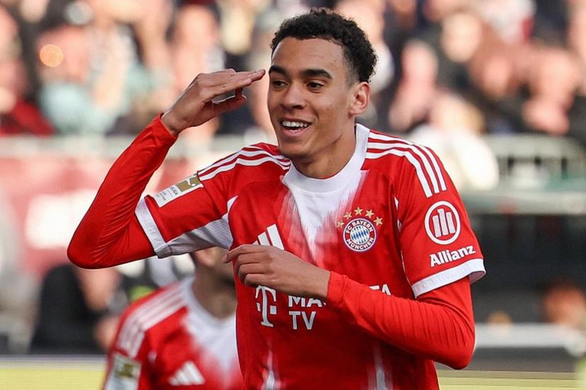 Bayern Munich's German midfielder #10 Jamal Musiala celebrates scoring the opening goal during the German first division Bundesliga football match between FC St Pauli and FC Bayern Munich in Hamburg, northern Germany, on April 11, 2026.  Ibo OT / AFP