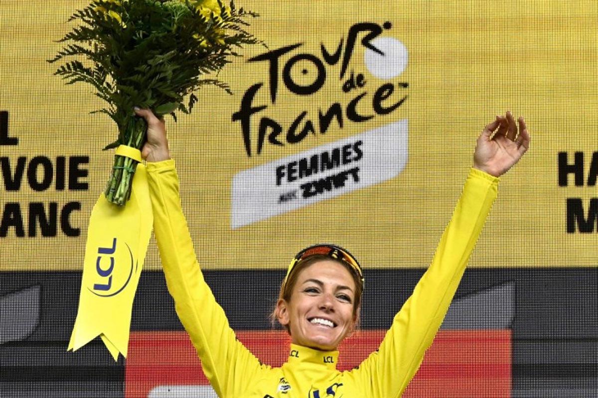 Team Visma | Lease a Bike's French rider Pauline Ferrand-Prevot celebrates with the overall leader's yellow jersey on the podium for the fourth edition of the Women's Tour de France cycling race at the end of the 9th and final stage (out of 9), 124.1 km from Praz-sur-Arly to Chatel, in Chatel eastern France, on August 3, 2025.  JULIEN DE ROSA / AFP