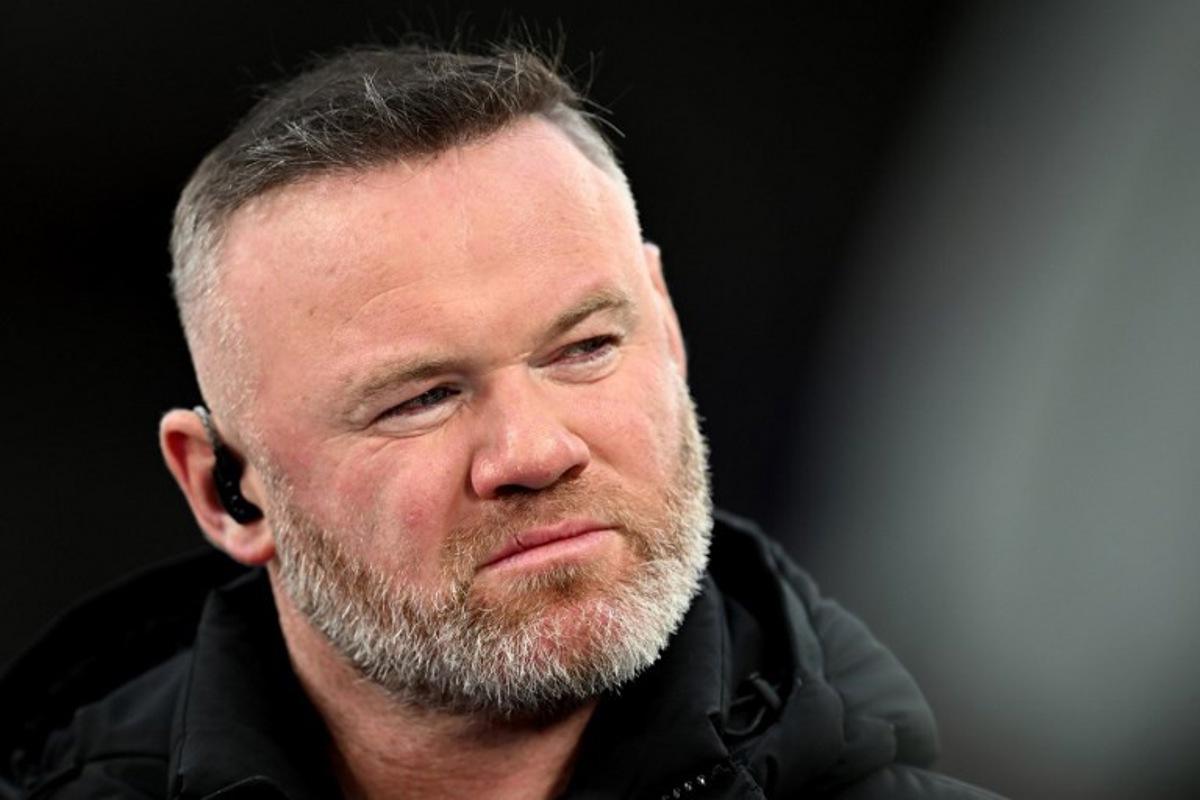 TV pundit and former footballer Wayne Rooney looks on before the UEFA Champions League quarter final, second-leg football match between Liverpool and Paris Saint-Germain at Anfield in Liverpool, north west England on April 14, 2026.  Paul ELLIS / AFP