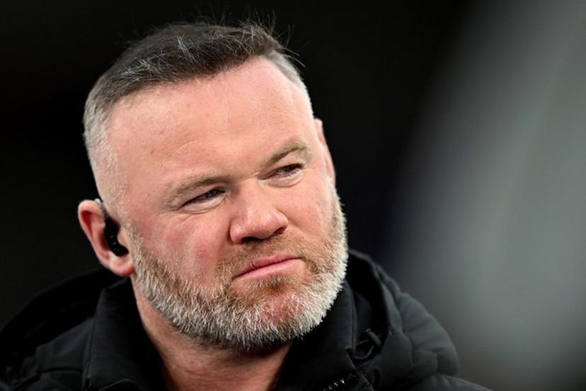TV pundit and former footballer Wayne Rooney looks on before the UEFA Champions League quarter final, second-leg football match between Liverpool and Paris Saint-Germain at Anfield in Liverpool, north west England on April 14, 2026.  Paul ELLIS / AFP