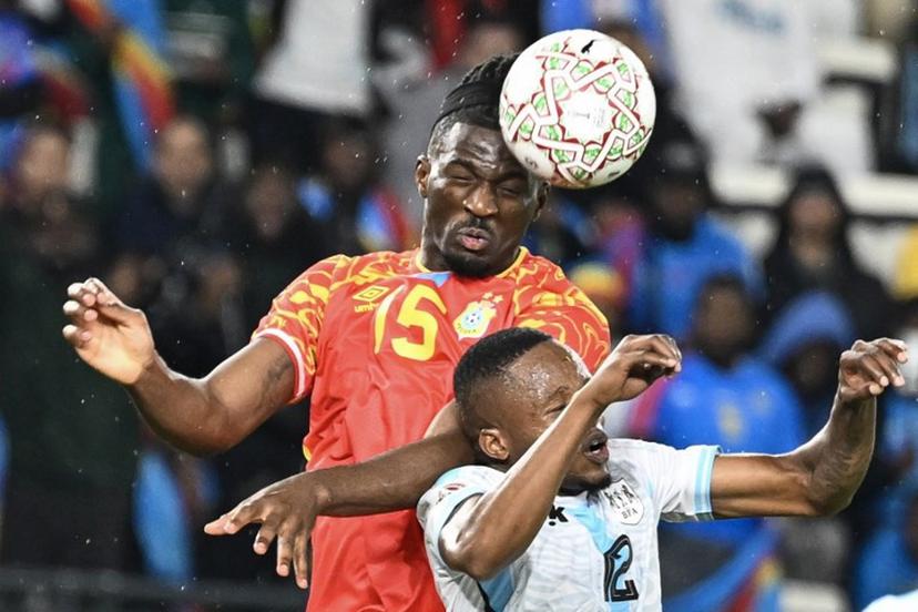 Democratic Republic Of Congo's defender #15 Rocky Bushiri and Botswana's defender #12 Mothusi Johnson vie during the Africa Cup of Nations (CAN) Group D football match between Botswana and Democratic Republic of Congo at El Madina Stadium in Rabat on December 30, 2025.   SEBASTIEN BOZON / AFP