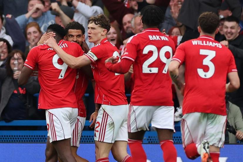 Nottingham Forest's Nigerian striker #09 Taiwo Awoniyi (L) celebrates with teammates after scoring his team's third goal during the English Premier League football match between Chelsea and Nottingham Forest at Stamford Bridge in London on May 4, 2026.  Adrian Dennis / AFP