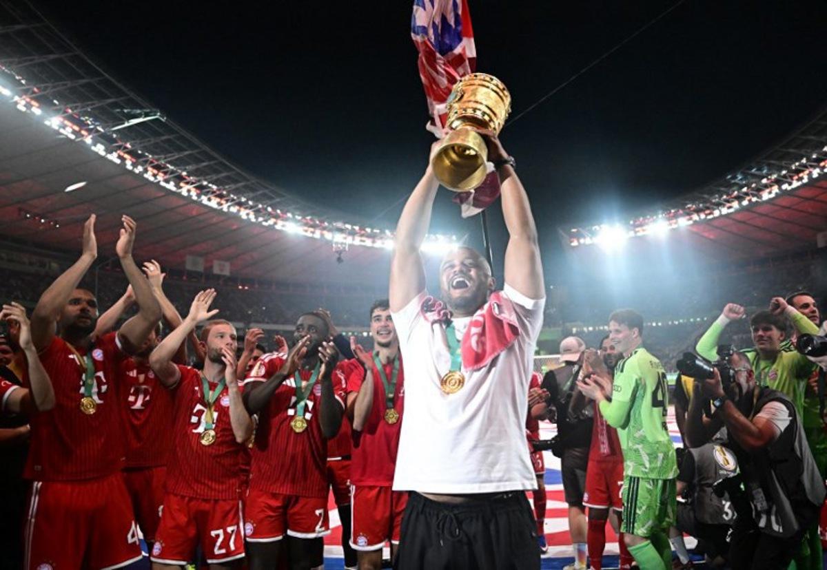Bayern Munich's Belgian head coach Vincent Kompany lifts the trophy after the German Cup (DFB Pokal) final football match FC Bayern Munich v VfB Stuttgart at the Olympic Stadium in Berlin, on May 23, 2026.  Tobias SCHWARZ / AFP