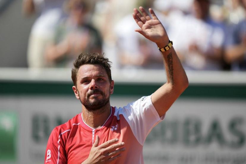 Switzerland's Stan Wawrinka waves to the spectators during a ceremony honoring his career on day 2 of the French Open tennis tournament on Court Simonne-Mathieu at the Roland-Garros Complex in Paris on May 25, 2026.  Dimitar DILKOFF / AFP