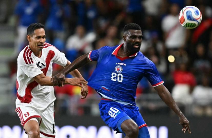 Haiti's forward #20 Frantzdy Pierrot and Peru's defender #15 Renzo Garces vie for the ball during the international friendly football match between Haiti and Peru at Nu Stadium in Miami, Florida on June 5, 2026.  CHANDAN KHANNA / AFP