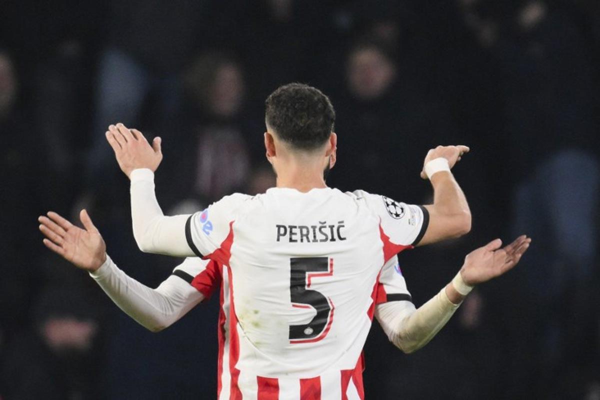 PSV Eindhoven's Moroccan midfielder #34 Ismael Saibari (unseen) celebrates with PSV Eindhoven's Croatian forward #05 Ivan Perisic after scoring his team's first goal during the UEFA Champions League league phase day 8 football match between PSV Eindhoven and Bayern Munich at Philips Stadion in Eindhoven on January 28, 2026.  JOHN THYS / AFP