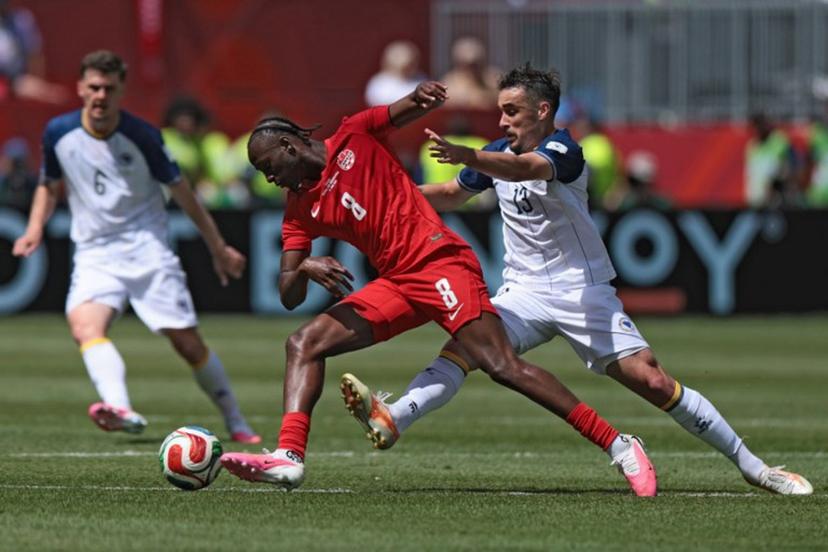 Canada's midfielder #08 Ismael Kone (C) fights for the ball with Bosnia-Herzegovina's midfielder #13 Ivan Basic during the 2026 World Cup Group B football match between Canada and Bosnia and Herzegovina at the Toronto Stadium in Toronto on June 12, 2026.  Cole Burston / AFP