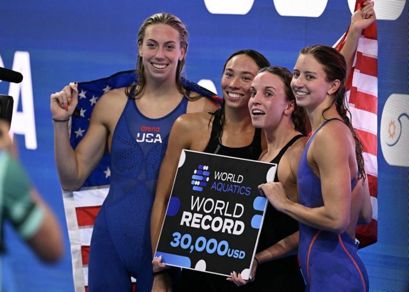 Team USA  US' swimmer Gretchen Walsh, US' swimmer Torri Huske, US' swimmer Regan Smith and US' swimmer Kate Douglass pose after winning the  final of the women's 4x100m medley relay swimming event during the 2025 World Aquatics Championships in Singapore on August 3, 2025.  Oli SCARFF / AFP