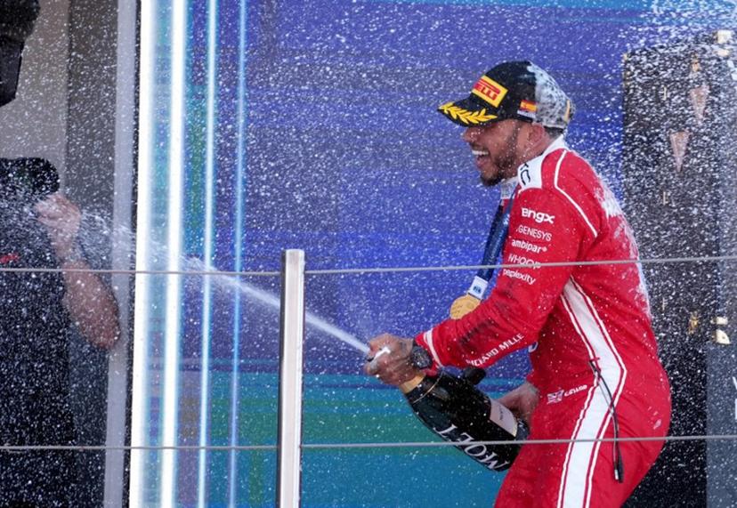 Ferrari's British driver Lewis Hamilton celebrates on the podium after winning the Catalonia Formula One Grand Prix at the Circuit de Catalunya in Montmelo, on the outskirts of Barcelona, on June 14, 2026.  Manaure QUINTERO / AFP