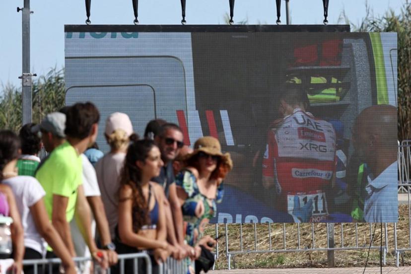 Team UAE's Slovenian rider Tadej Pogacar is seen entering an ambulance after crashing on a giant screen in the finish area of the Vuelta a Espana 2026, a 171 km race between Pucol and Xeraco on August 29, 2026.   Race leader Tadej Pogacar pulled out of the Vuelta a Espana on Saturday after a heavy fall 31km from the finish of a flat stage eight left him with shoulder and face injuries. Pogacar of Team UAE has won five Tour de France titles and a Giro d'Italia and was targeting his first overall victory on the Spanish 21-day race.  Josep LAGO / AFP