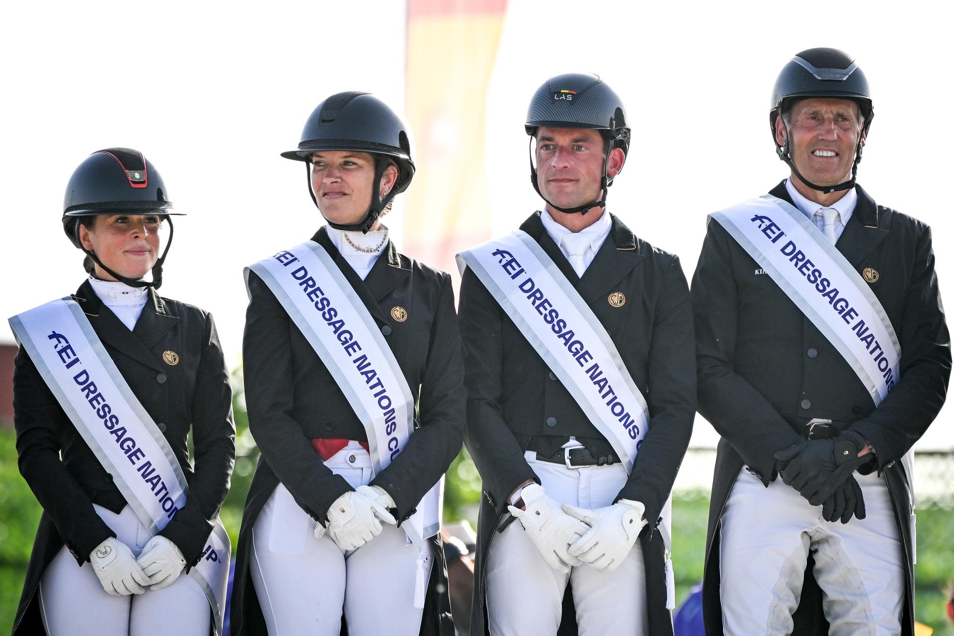 Belgian Charlotte Defalque, Belgian Larissa Pauluis, Belgian Justin Verboomen and Belgian Wim Verwimp pictured during the podium ceremony after the Dressage Nations Cup FEI CDIO4 equestrian event in Koningshooikt, Lier on Saturday 23 May 2026. BELGA PHOTO ELIAS ROM